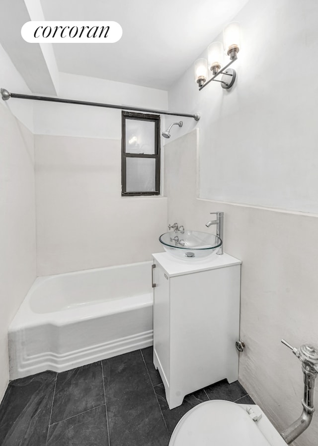 full bathroom featuring vanity, bathtub / shower combination, and toilet