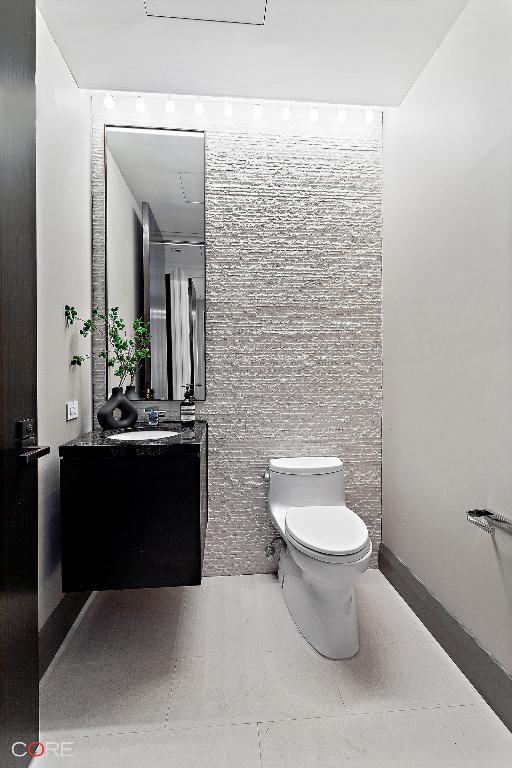 bathroom featuring vanity, toilet, and tile patterned flooring