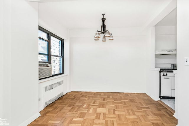 unfurnished dining area featuring baseboards, radiator heating unit, cooling unit, and a notable chandelier