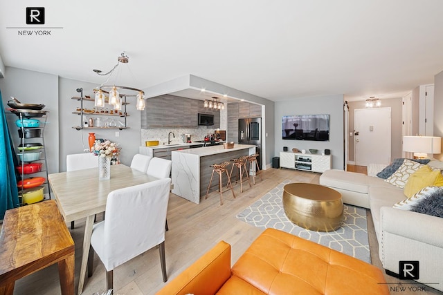 555 Kappock St Unit 8-H, New York City, NY 10463 - living room featuring light wood-style flooring and a chandelier