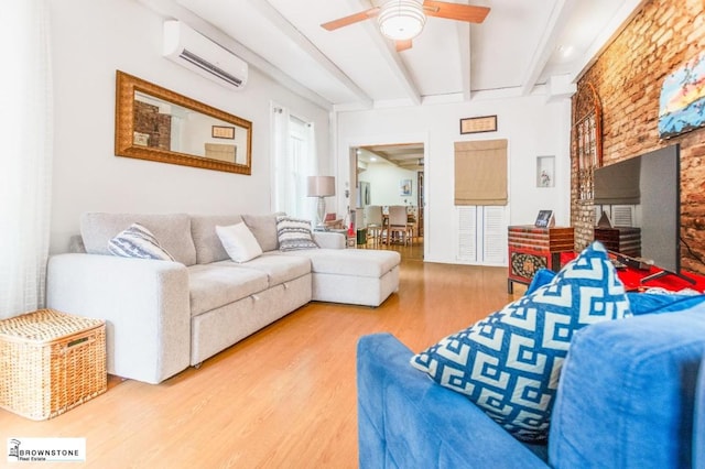 living room featuring ceiling fan, wood-type flooring, beamed ceiling, and a wall mounted AC