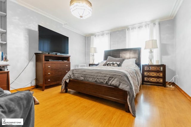 bedroom with crown molding and hardwood / wood-style flooring