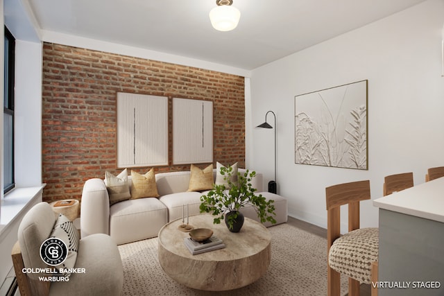 living room with light hardwood / wood-style floors, a baseboard radiator, and brick wall