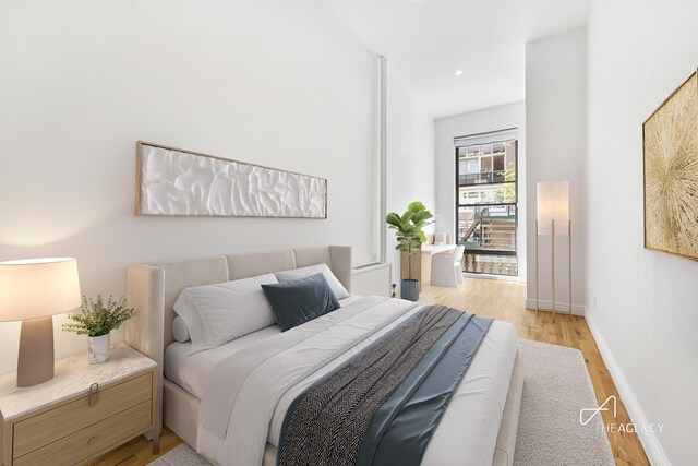 bedroom with light wood finished floors, baseboards, and recessed lighting