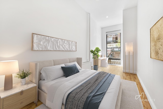 bedroom with recessed lighting, baseboards, and light wood-type flooring