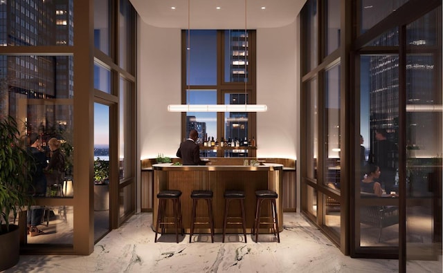 bar featuring pendant lighting and floor to ceiling windows