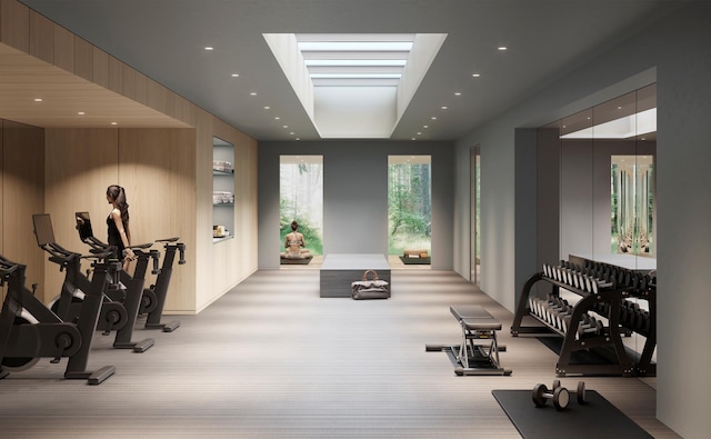 exercise area featuring recessed lighting and a tray ceiling