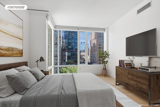 bedroom featuring visible vents and light wood finished floors