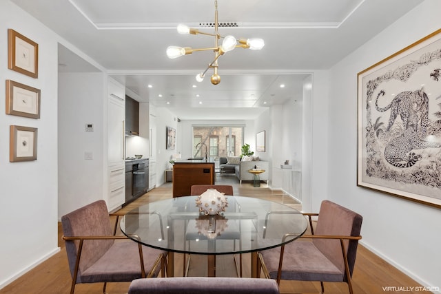 dining room featuring light wood-style floors, recessed lighting, baseboards, and an inviting chandelier