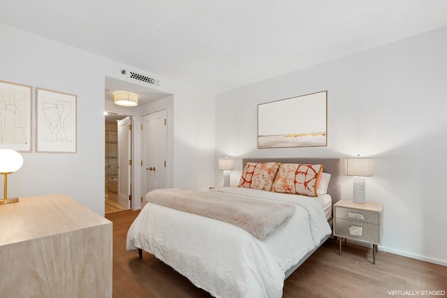 bedroom with hardwood / wood-style floors