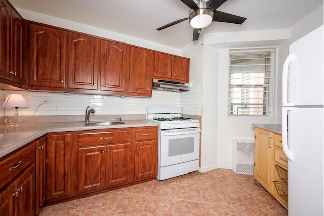 kitchen with white appliances, sink, light tile patterned flooring, ceiling fan, and tasteful backsplash