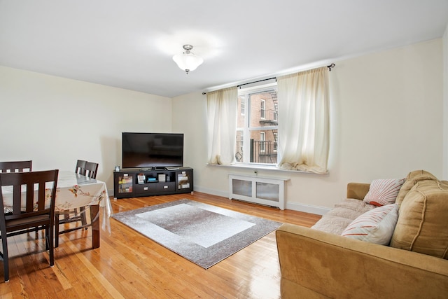 living room with light wood-style flooring and baseboards
