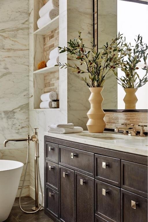 bathroom featuring vanity, tile walls, and a tub