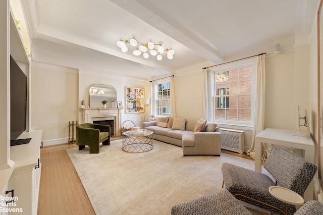 living area featuring beam ceiling, a fireplace, light wood-style flooring, an AC wall unit, and baseboards