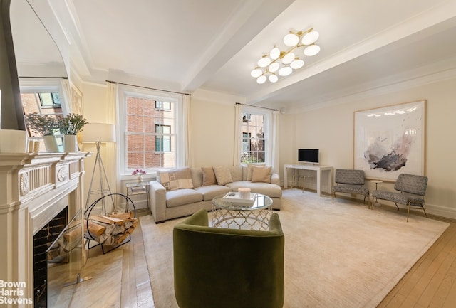 living room featuring light wood-style flooring, a fireplace with flush hearth, ornamental molding, beamed ceiling, and baseboards