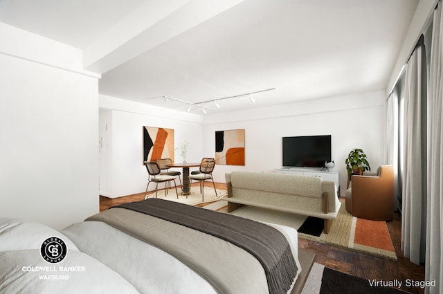 bedroom with rail lighting and dark parquet flooring