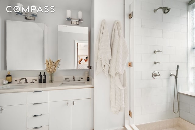 full bathroom with a stall shower and double vanity
