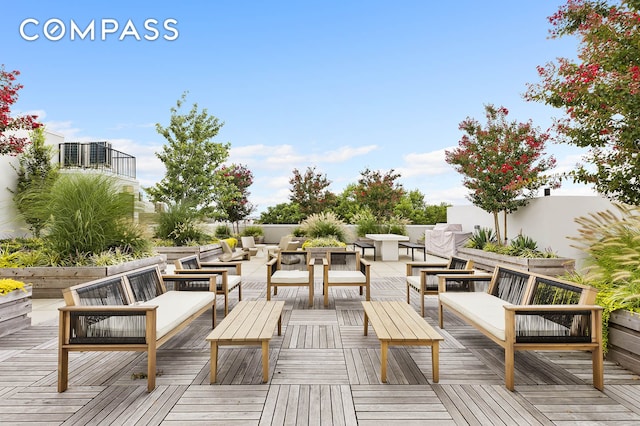 wooden terrace featuring an outdoor hangout area and central AC