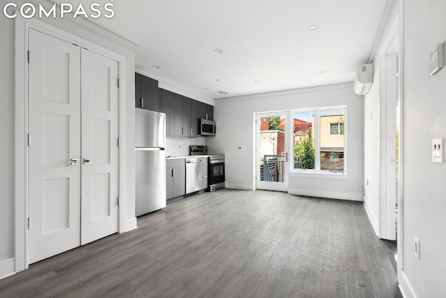 kitchen with tasteful backsplash, crown molding, dark wood-type flooring, and appliances with stainless steel finishes