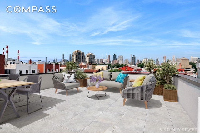 view of patio / terrace with a view of city and an outdoor hangout area