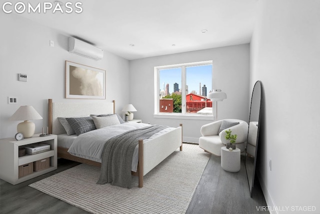 bedroom with a wall mounted air conditioner and dark hardwood / wood-style floors