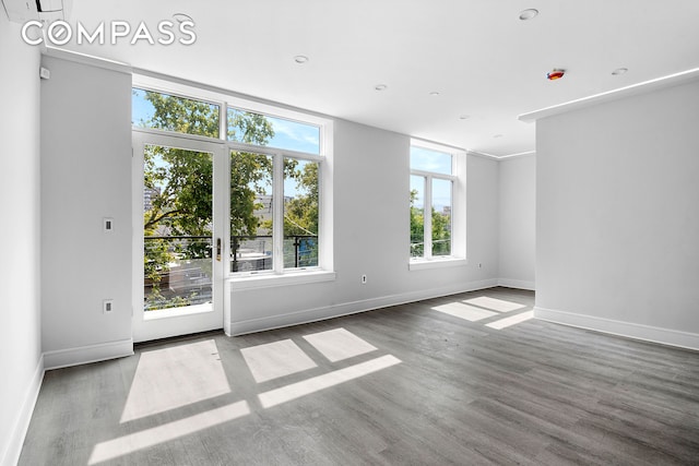 interior space with baseboards and wood finished floors