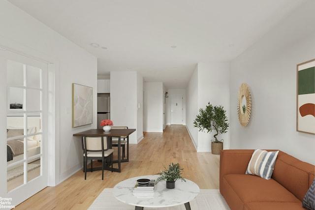 living room with light wood finished floors and baseboards