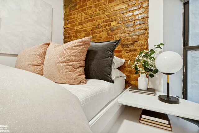 interior space featuring brick wall