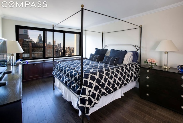 bedroom featuring dark hardwood / wood-style flooring and crown molding