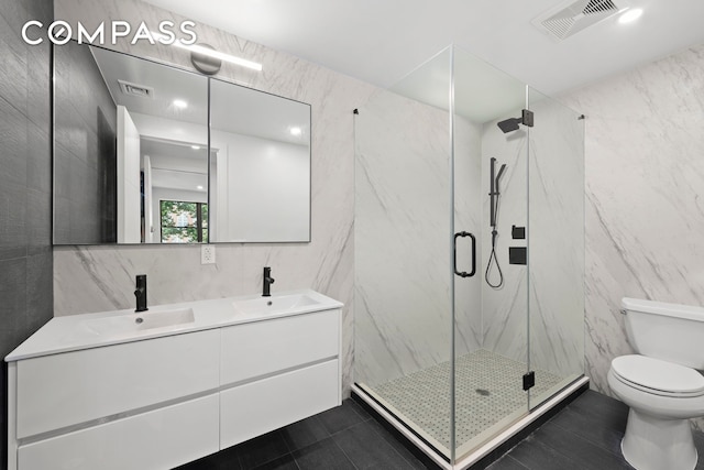 bathroom with tile walls, visible vents, and a sink