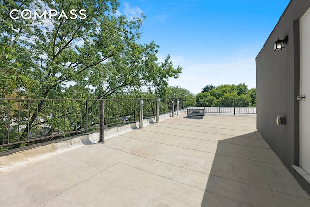 view of patio featuring a balcony