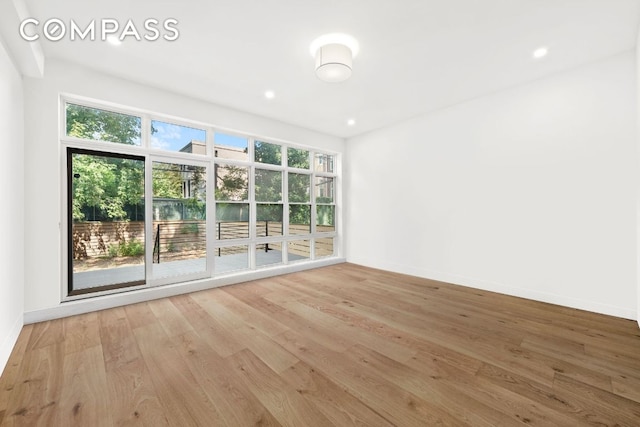 unfurnished room with light wood-type flooring