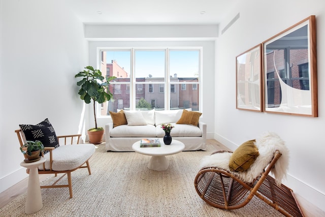 living area featuring baseboards and wood finished floors