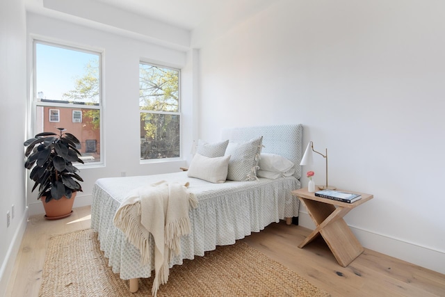 bedroom featuring baseboards and wood finished floors