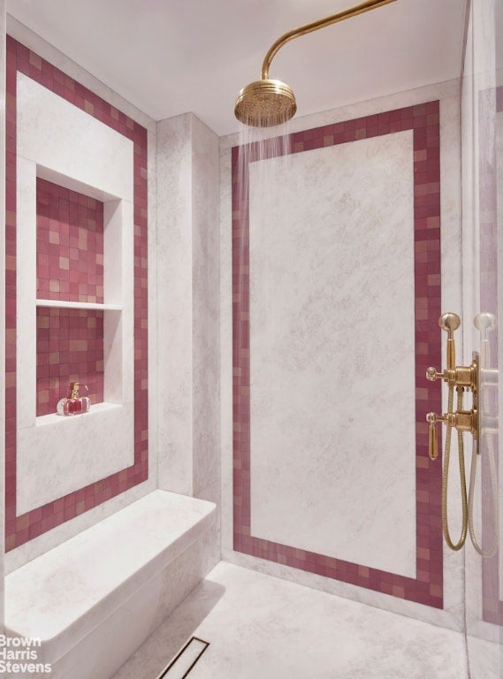 bathroom with a tile shower