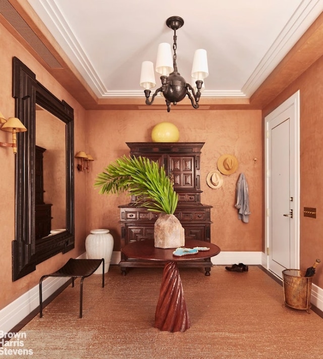 living area featuring an inviting chandelier and ornamental molding