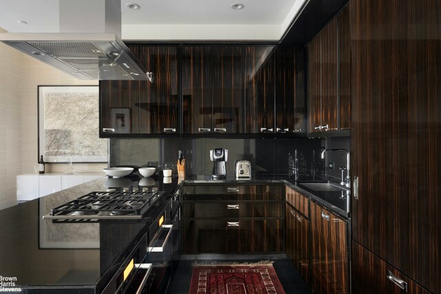 kitchen with stainless steel gas cooktop, island exhaust hood, a sink, dark brown cabinetry, and modern cabinets