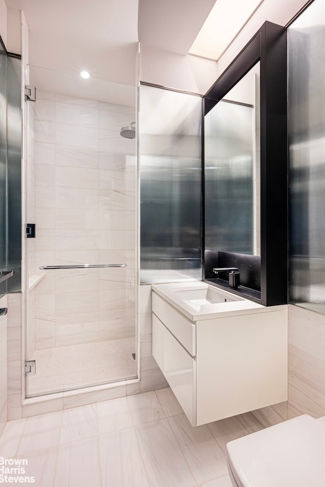 bathroom with a stall shower, vanity, and recessed lighting