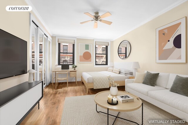 living room with hardwood / wood-style floors, ornamental molding, and ceiling fan