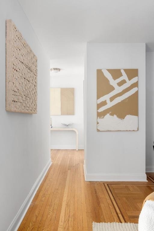 hallway with hardwood / wood-style flooring