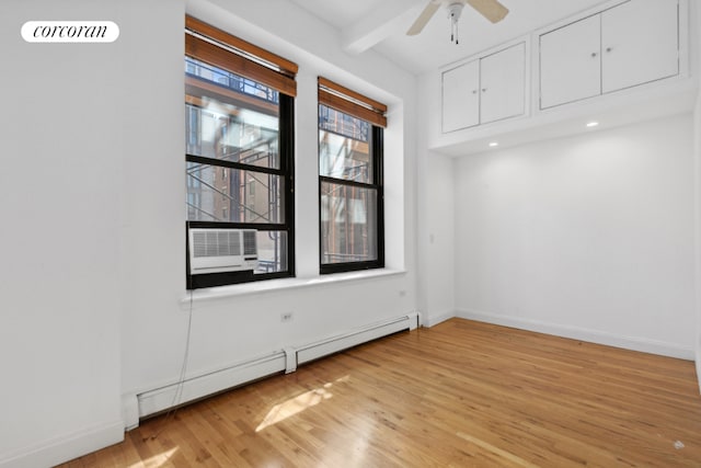 spare room with a baseboard radiator, cooling unit, ceiling fan, light hardwood / wood-style floors, and beam ceiling