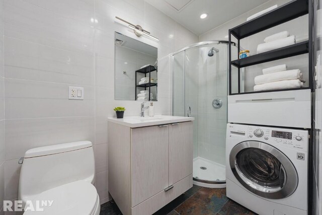 bathroom with walk in shower, tile walls, vanity, and toilet