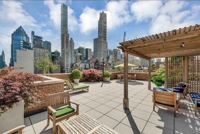 view of patio featuring outdoor dining area, a city view, and a pergola