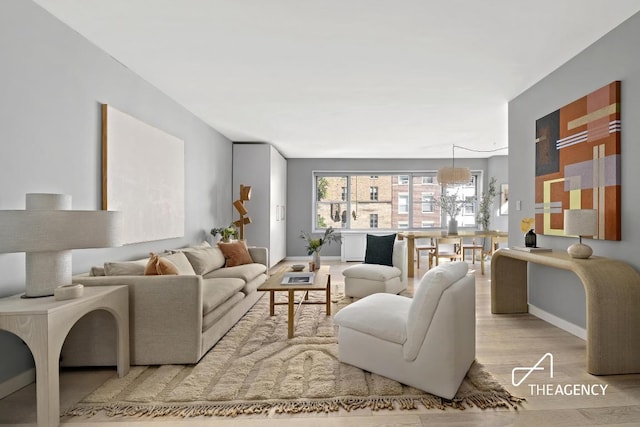 living room featuring light wood finished floors and baseboards