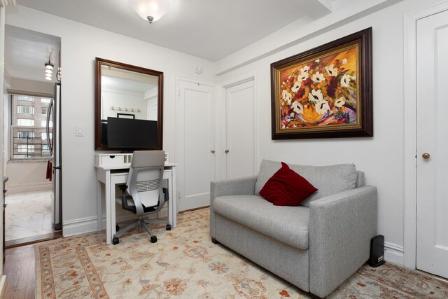 home office featuring light wood-type flooring and baseboards