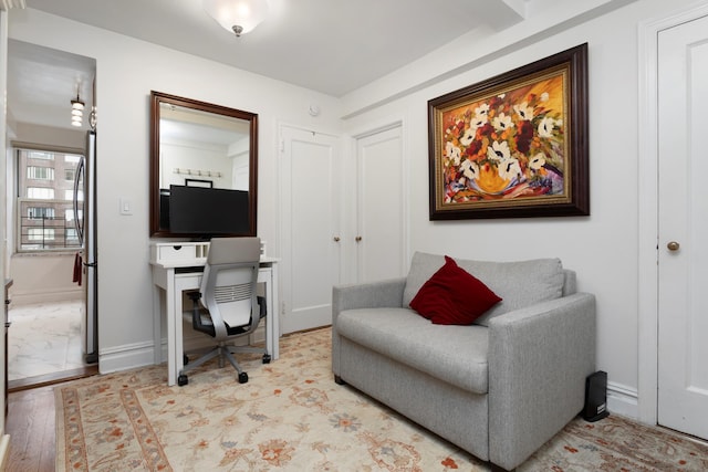 office with baseboards and light wood-style floors