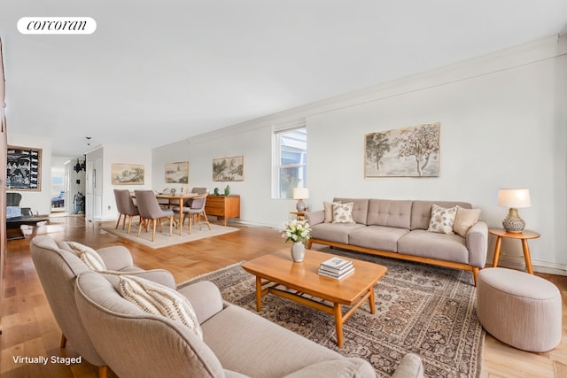 living room featuring wood-type flooring and ornamental molding