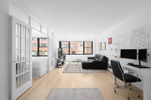 home office featuring crown molding and light hardwood / wood-style floors