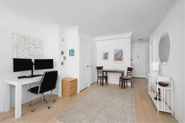 office with light wood-style floors and ornamental molding