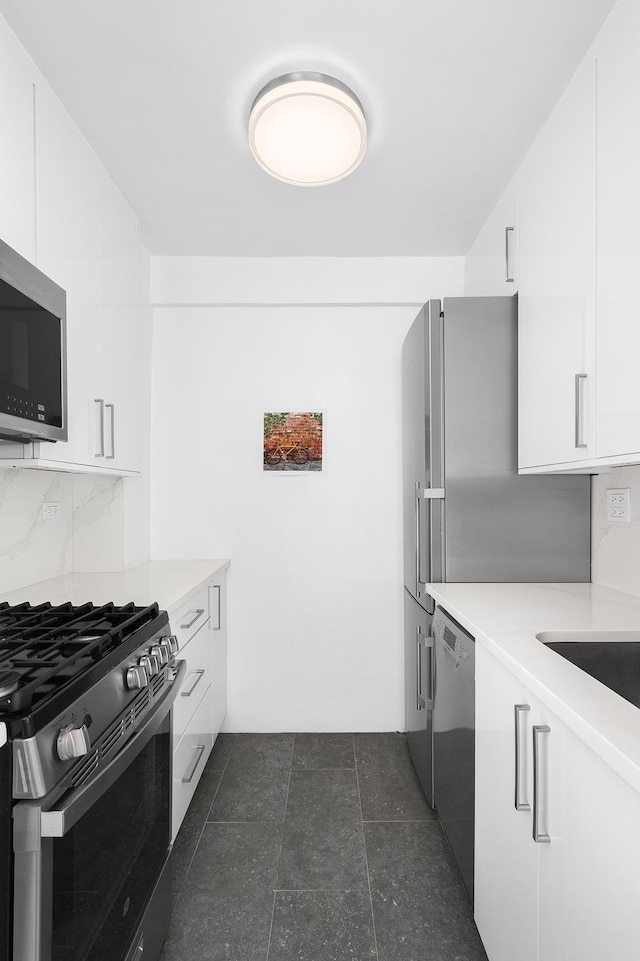 kitchen with white cabinets, stainless steel appliances, and backsplash